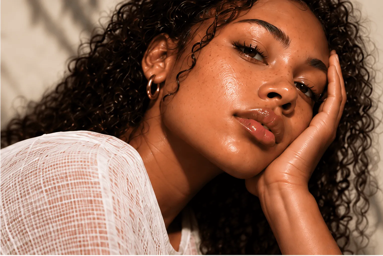 Portrait of a person resting their face against one hand